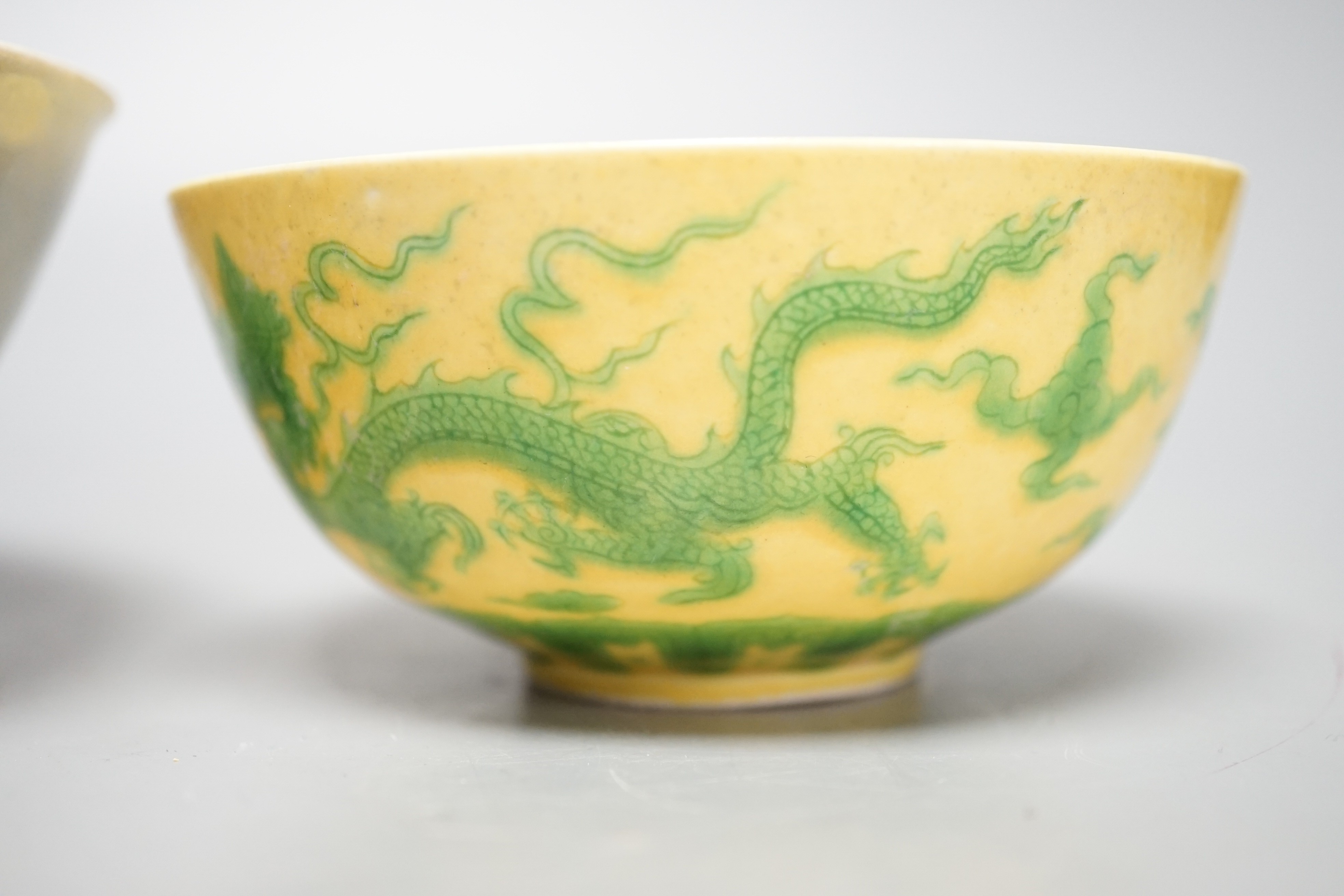 A Chinese Teksing cargo bowl c1820 and a yellow ground 'dragon' bowl. Largest 16cm diameter.